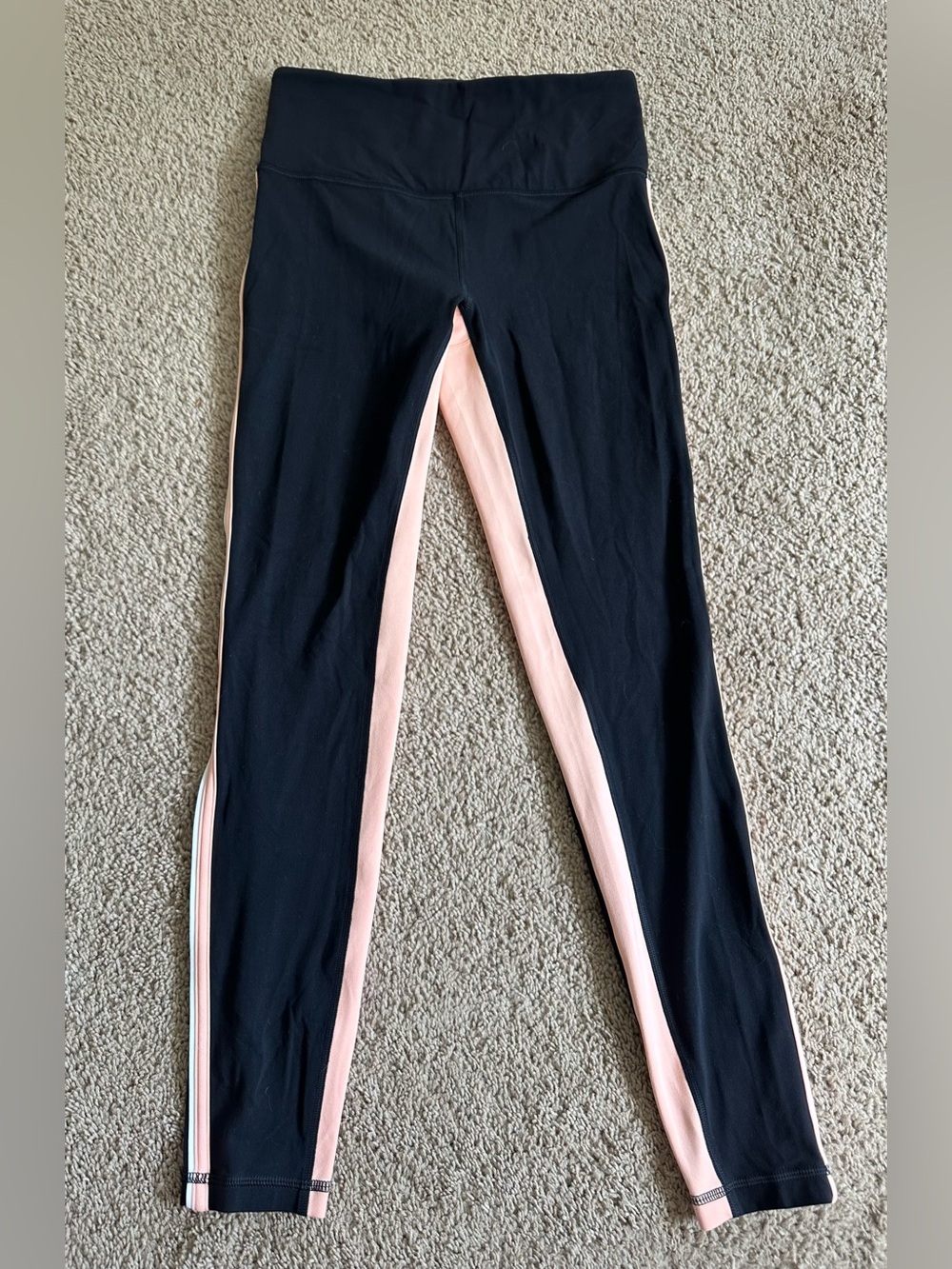 Athleta Black Leggings with Light Pink Side Stripes.